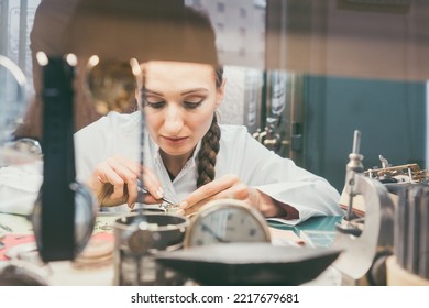 Woman Watchmaker Working Diligently On Repairing A Watch