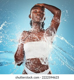 Woman, Water Splash And Skincare Body, Beauty Moisturiser Or Hydration By Blue Background Wall. Black Woman, Skin Model And Splashes For Cosmetics, Health Or Dermatology Wellness By Cosmetic Backdrop