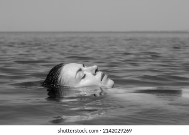 Woman in the water.A beautiful woman without makeup dipped her face into the water. The idea of ​​freshness, hydration. Skin hydration, relaxation.  - Powered by Shutterstock