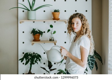 Woman Watering Indoor Potted Plants