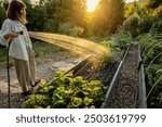 A woman waters her garden in the early morning, surrounded by lush greenery and a stunning mountain view. The peaceful moment captures the essence of life in harmony with nature