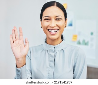 Woman Waving Hand To Greet Hello While Introducing, Smiling And Gesturing During Video Call Via Webcam In Virtual Meeting In An Office. Portrait Of A Young, Friendly And Happy Female Business Intern