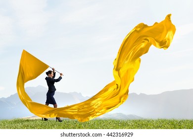 Woman Waving Yellow Flag