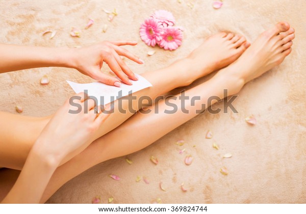 Woman waxing\
legs