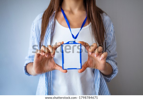 Woman wear\
blank ID badge mockup, stand isolated. Name tag on neck and chest.\
Person identity label. Women in shirt uniform with empty id card\
mock up. Bussinesswoman lanyard\
design.