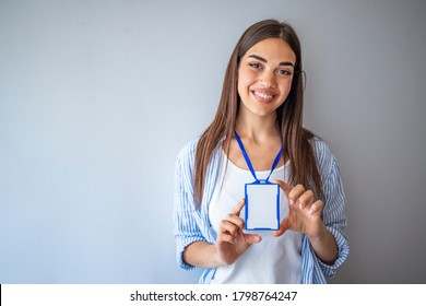 Woman wear blank vertical ID badge mockup, stand isolated. Name tag on neck and chest. Person identity label. Women in shirt uniform with empty id card mock up. Bussinesswoman lanyard design. - Powered by Shutterstock