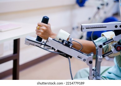 Woman Wear Machine Arm For Physical Therapy. By Defining How A Robot Driven Moving Technique Can Be Improved To Achieve Better Results In Physical Rehabilitation.