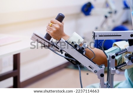 woman wear machine arm for physical therapy. By defining how a robot driven moving technique can be improved to achieve better results in physical rehabilitation.