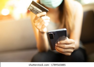 A Woman Wear A Mask Is Shopping Online Via Credit Card In Coffee Cafe