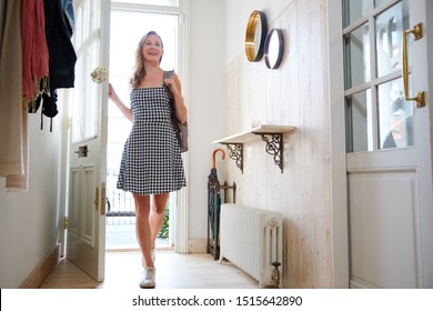 Woman Wearing Backpack Opening Front Door Coming Home From Work