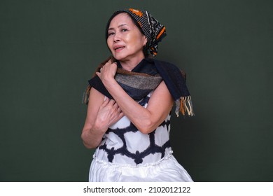 A Woman Wearing Bandana, Adjusting Her Shawl.