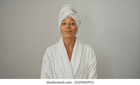 Woman wearing bathrobe with towel wrapped on head against white background, mature and beautiful, isolated and looking content - Powered by Shutterstock