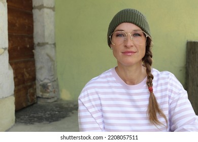 Woman Wearing Beanie, Retro Eyeglasses And Braided Hair 