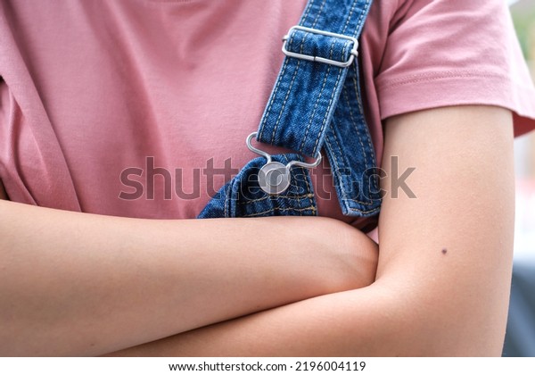 Woman Wearing Bib\
Overalls with mole on\
skin
