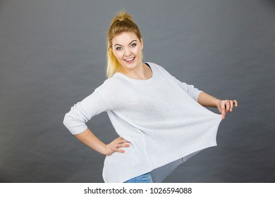 Woman Wearing Too Big Jumper, Not Fitting After Weight Loss. Grey Background