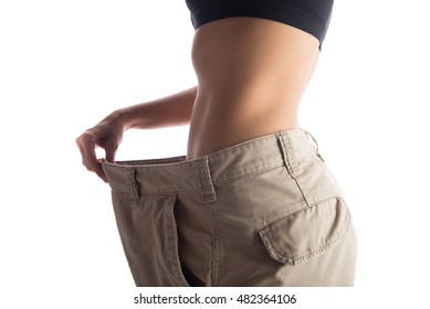 Woman Wearing Bigger Pant After Lose Weight From Work Out Exercise On White Background