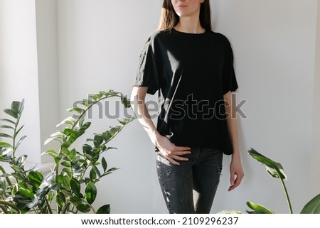 young beautiful lady posing in the living room next to a window