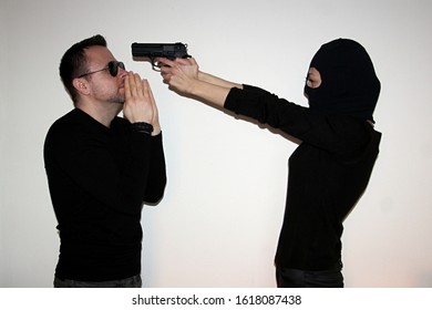 Woman Wearing Black Helmet And Putting Gun To Man