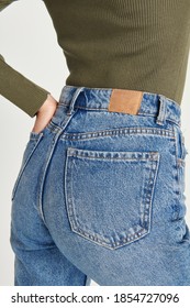 Woman Wearing Blue Jeans With A Brown Tag Mockup