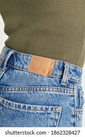 Woman Wearing Blue Jeans With A Brown Tag Mockup