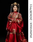 Woman wearing Chinese Ming Dynasty Hanfu clothing against black background