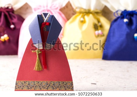 The woman wearing colorful Hanbok, Korean traditional dress isolated on the white background.
