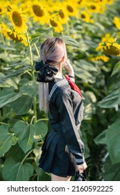 Woman Wearing Cosplay Japanese School Uniform At Sunflower Garden Outdoor.