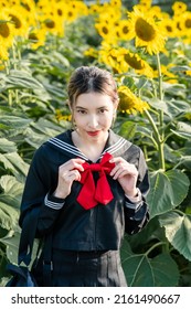 Woman Wearing Cosplay Japanese School Uniform At Sunflower Garden Outdoor.