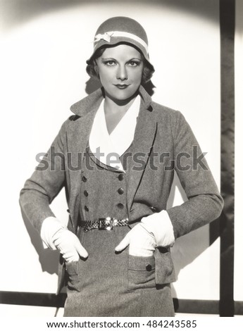 Woman wearing dress suit with matching hat