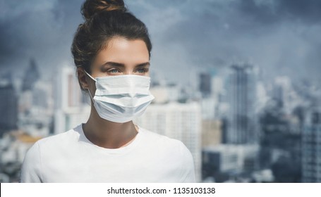 Woman wearing face mask because of air pollution in the city - Shutterstock ID 1135103138