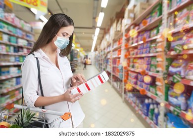 Woman Wearing Face Mask Buying In The Supermarket With Shopping Cart