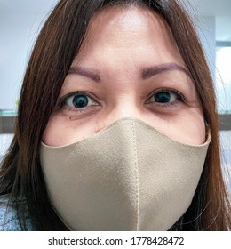 Woman Wearing A Face Mask Due To Coronavirus Safety Measures And With Clinical Sign Of Mydriasis. Date: 07/07/20 Place: Lima, Peru.