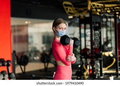 Woman Wearing Face Mask Exercise Workout In Gym During Corona Virus Pandermic, Covid