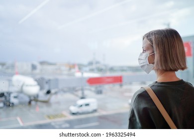 Woman wearing a face mask for prevent virus in international airport. Protection against Coronavirus.