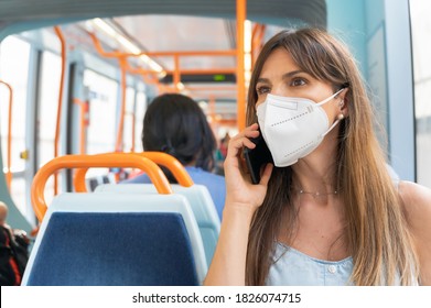 Woman Wearing Face Mask Talking On The Phone Onboard Train. High Quality Photo