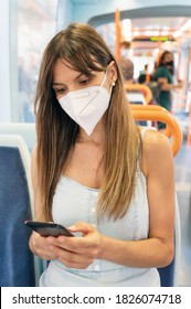 Woman Wearing Face Mask Using Mobile Phone Onboard Train. High Quality Photo