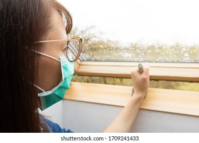 Woman Wearing Facial Medical Mask Opening Window In A Sunny Day