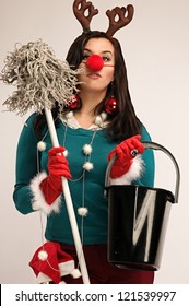 Woman Wearing Festive Decorations Ready For Cleaning After Christmas