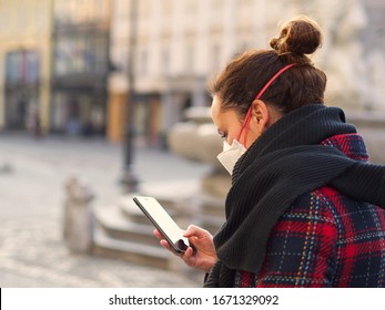 Woman wearing FFP3 face protection mask, since new coronavirus Sars-CoV-2 and a flu have emerged doing regular activities like using phone, walking in a city centre. - Powered by Shutterstock