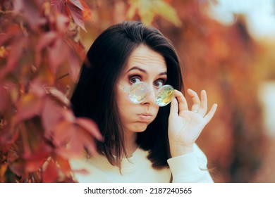 
Woman Wearing Funny Glasses Having A Surprised Reaction
Fashionable Girl Wearing Party Colorful Eyeglasses Wondering In Shock 

