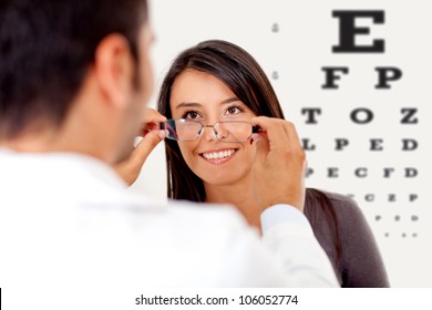 Woman wearing glasses after taking a vision test at the doctor