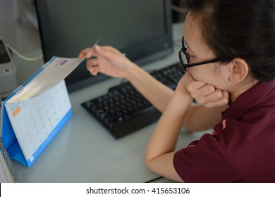 Woman Wearing Glasses Looking At The Calendar