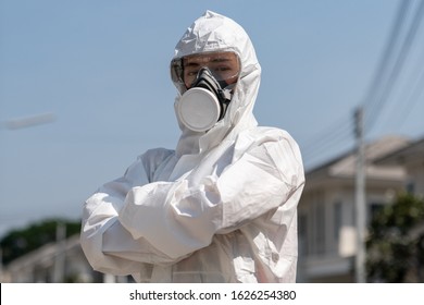 Woman wearing gloves with biohazard chemical protective suit and mask. She crossed her arms with unhappy face. 