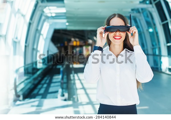 woman wearing goggles in futuristic interior - \
wearables concept