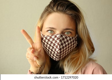 Woman wearing handmade cotton cloth face mask and making selfie at home. Corona virus concept. Quarantine concept. Reusable face mask. - Powered by Shutterstock