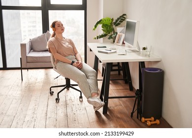 Woman Wearing Headphones With Arm Implant Sitting With Closed Eyes At The Table