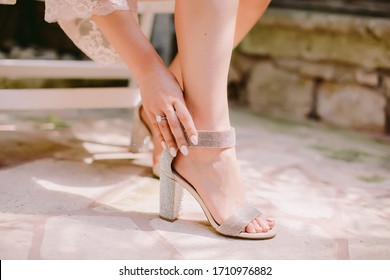 woman wearing high heel shoes with sparkles. Bride wearing shoes close up shot with engagement ring.