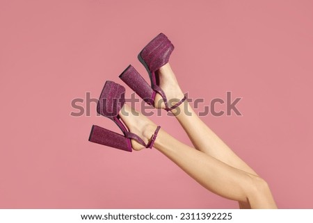 Woman wearing high heeled shoes with platform and square toes on pink background, closeup