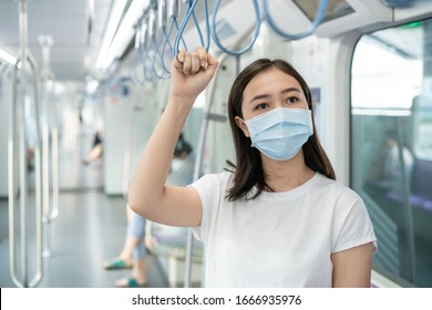 Woman wearing a hygiene protective mask to protect COVID19 virus and pm2.5 pollution while traveling in the crowded place. Woman use face mask to protect corona virus crisis in Asian country. Sickness - Powered by Shutterstock