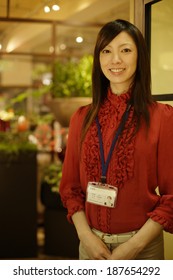 Woman Wearing ID Badge On Lanyard Around Her Neck